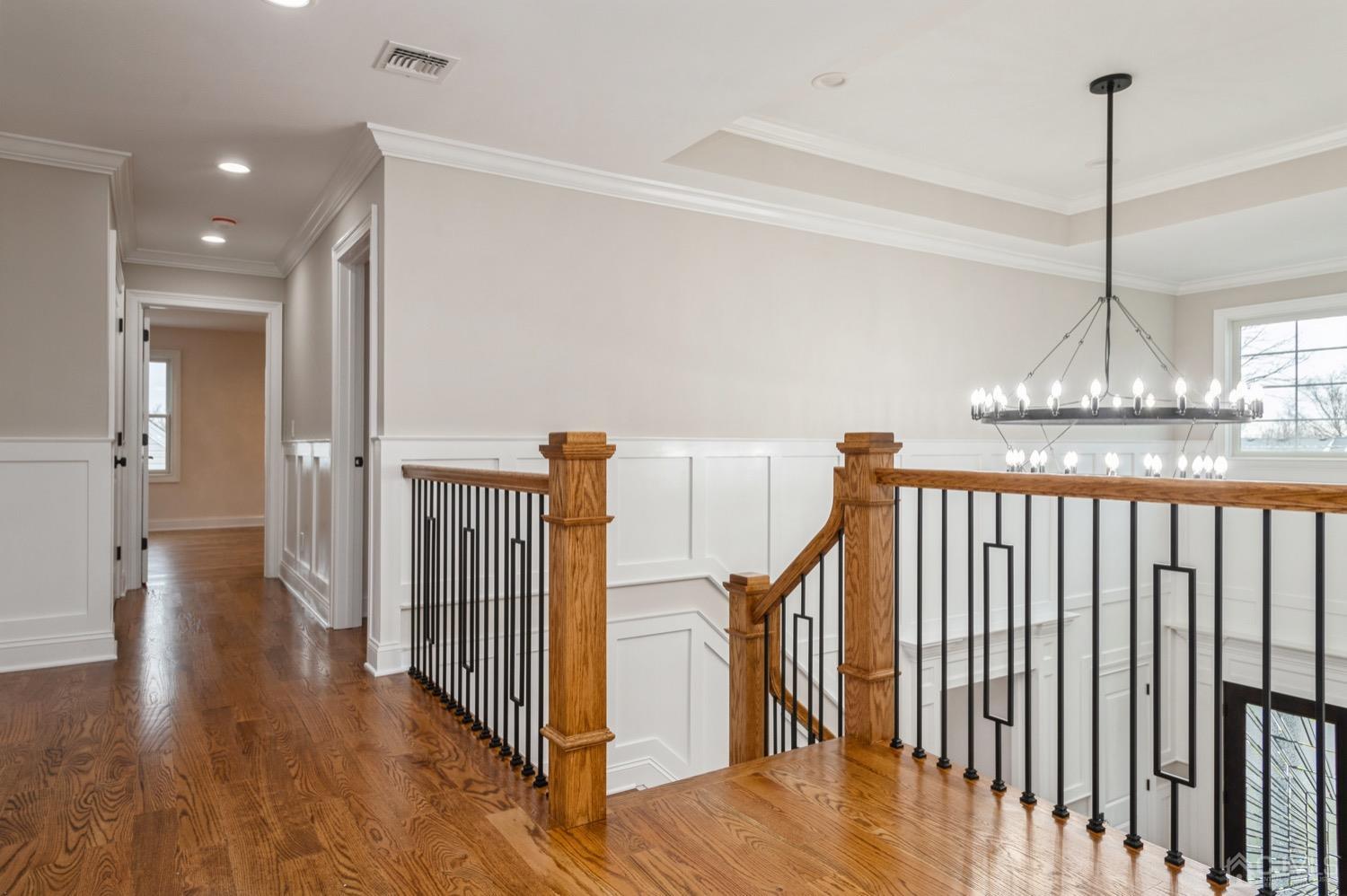 71 South Hill Road Colonia, NJ 07067 - Photo 18 of 40 a view of a hallway with wooden floor and stairs
