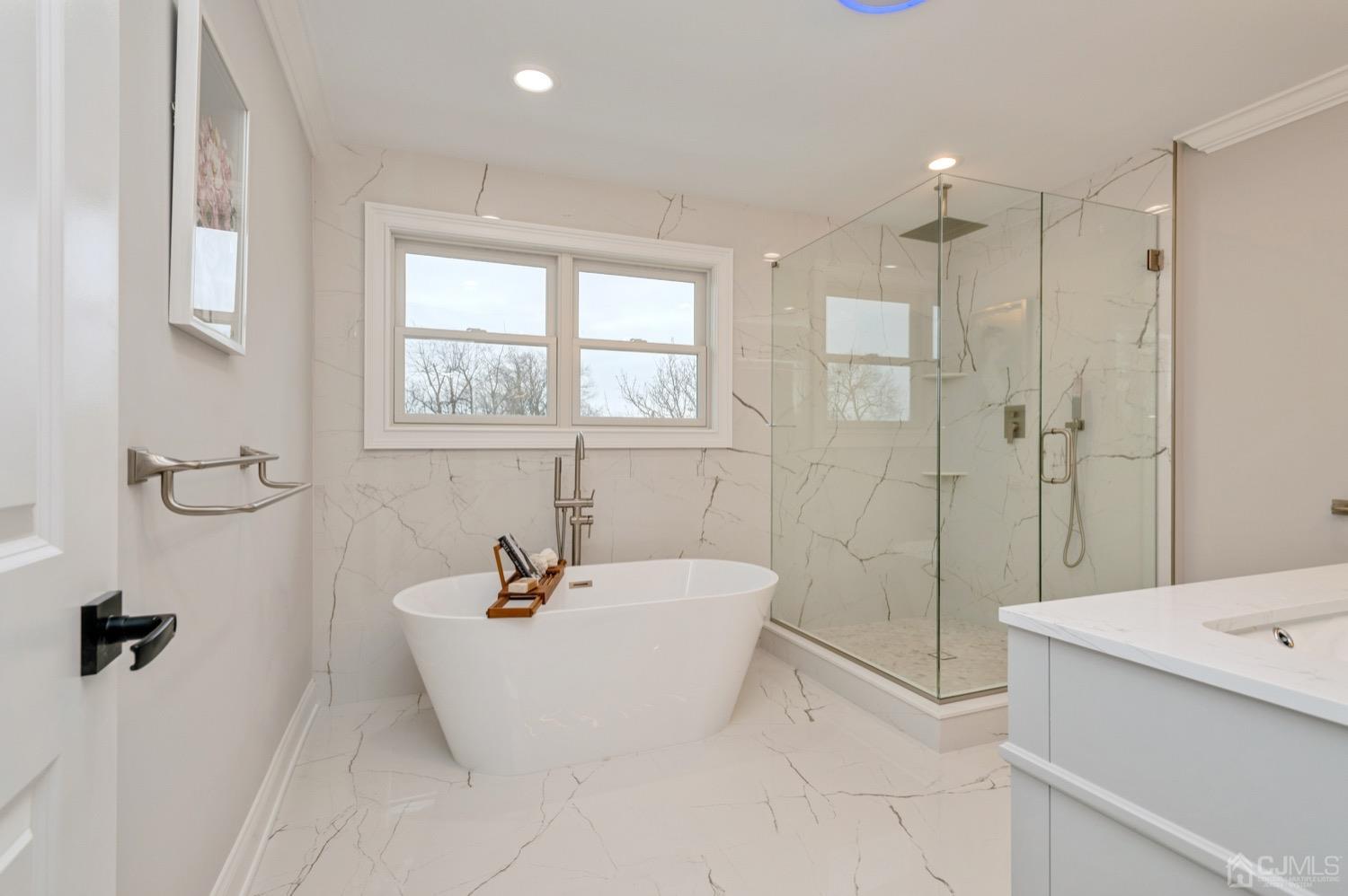 71 South Hill Road Colonia, NJ 07067 - Photo 22 of 40 a bathroom with a sink a tub and shower