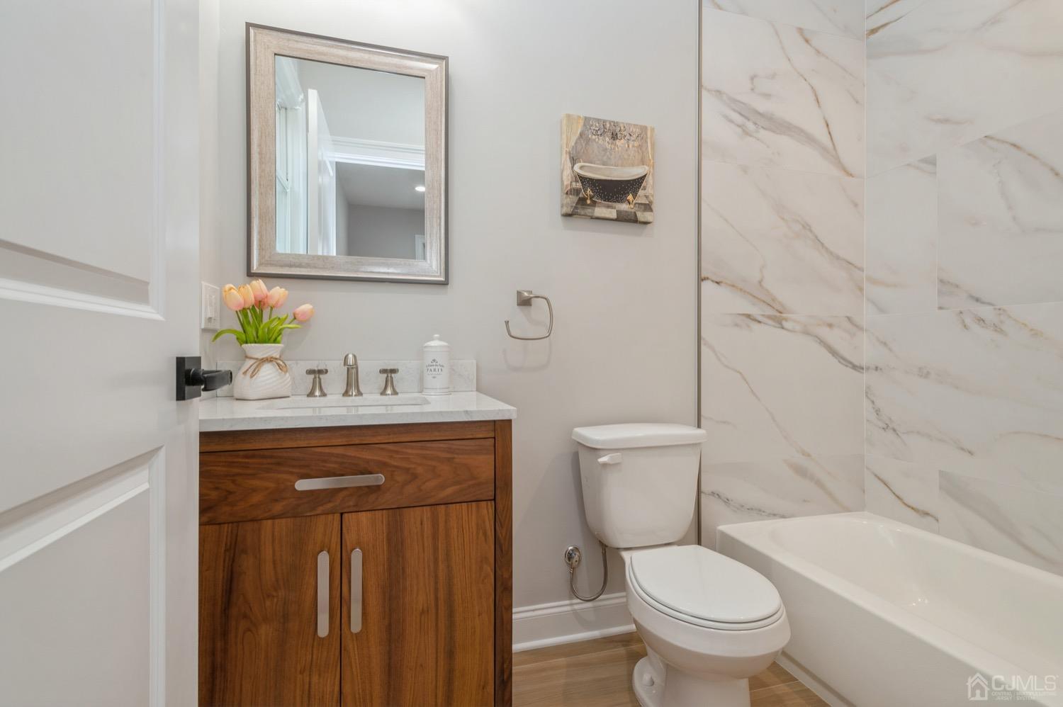 71 South Hill Road Colonia, NJ 07067 - Photo 25 of 40 a bathroom with a toilet sink and mirror