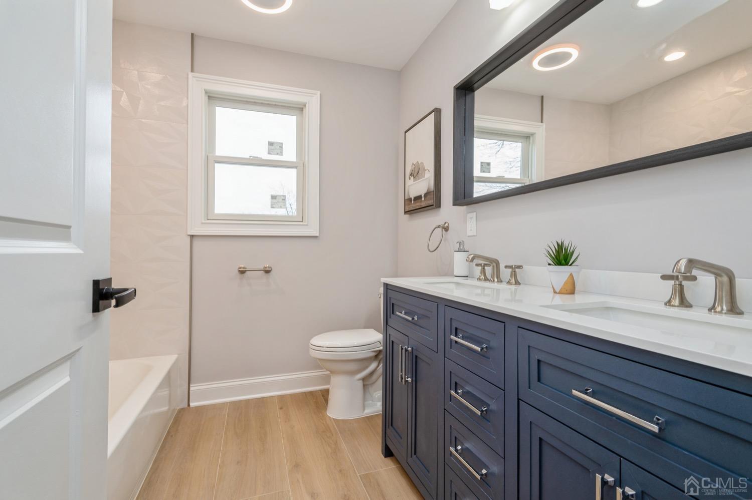 71 South Hill Road Colonia, NJ 07067 - Photo 31 of 40 a spacious bathroom with a granite countertop toilet sink and mirror
