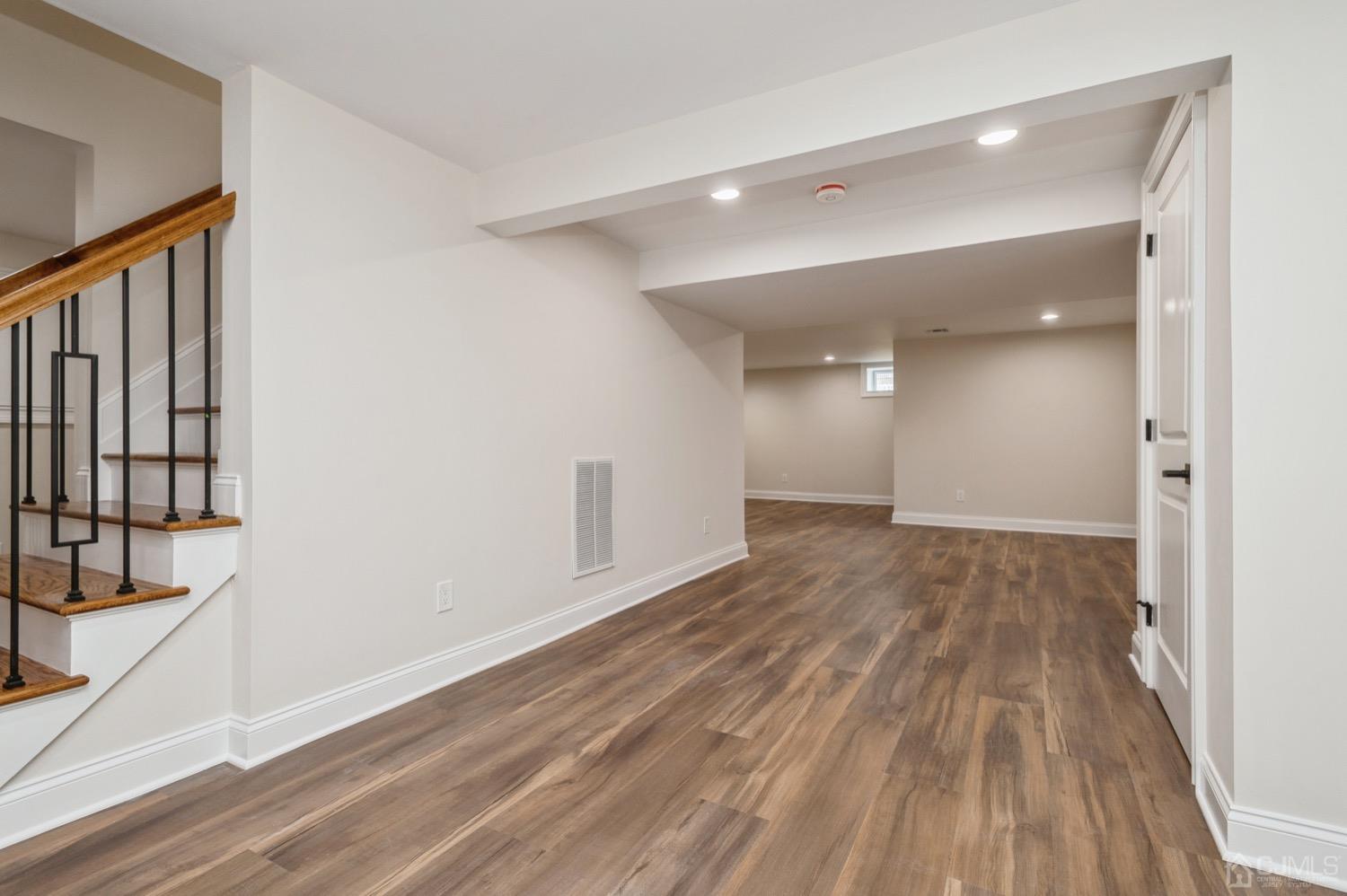 71 South Hill Road Colonia, NJ 07067 - Photo 32 of 40 a view of a room with wooden floor and staircase