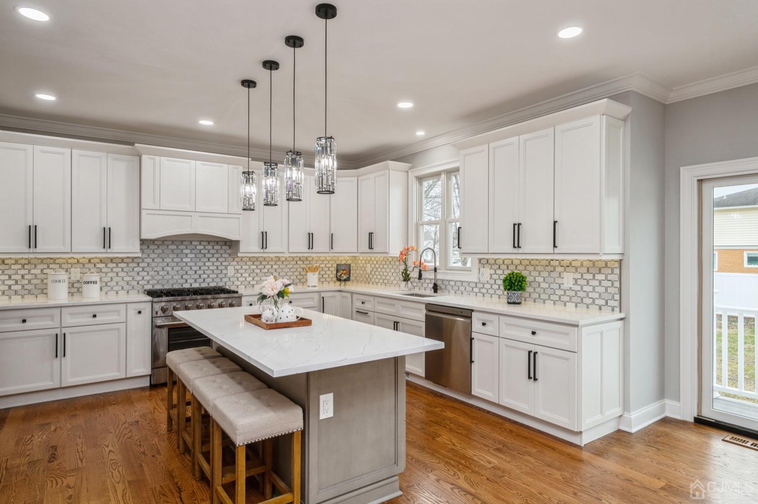 71 South Hill Road Colonia, NJ 07067 - Photo 10 of 40 a kitchen with a stove cabinets and wooden floor