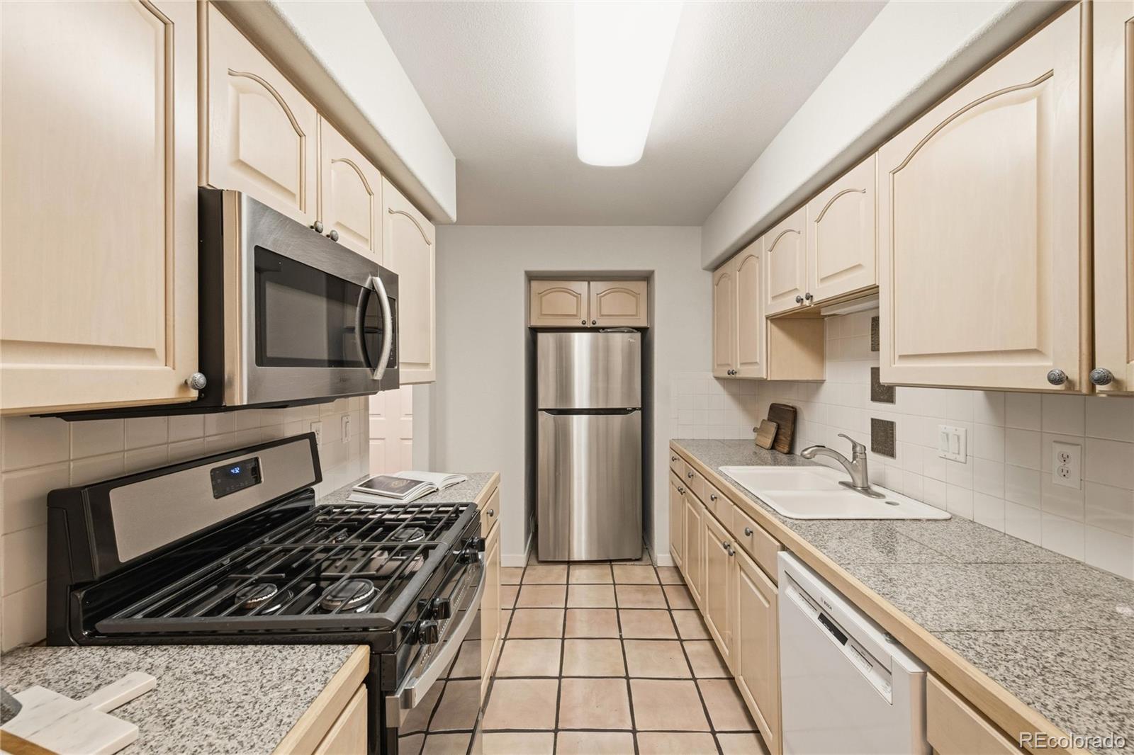 563 Ridgeview Drive Louisville, CO 80027 - Photo 14 of 33 a kitchen with a sink stove and microwave