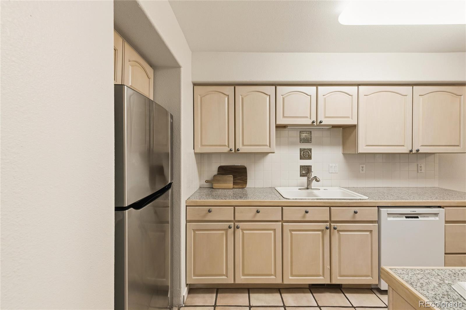 563 Ridgeview Drive Louisville, CO 80027 - Photo 16 of 33 a kitchen with stainless steel appliances a refrigerator sink and cabinets