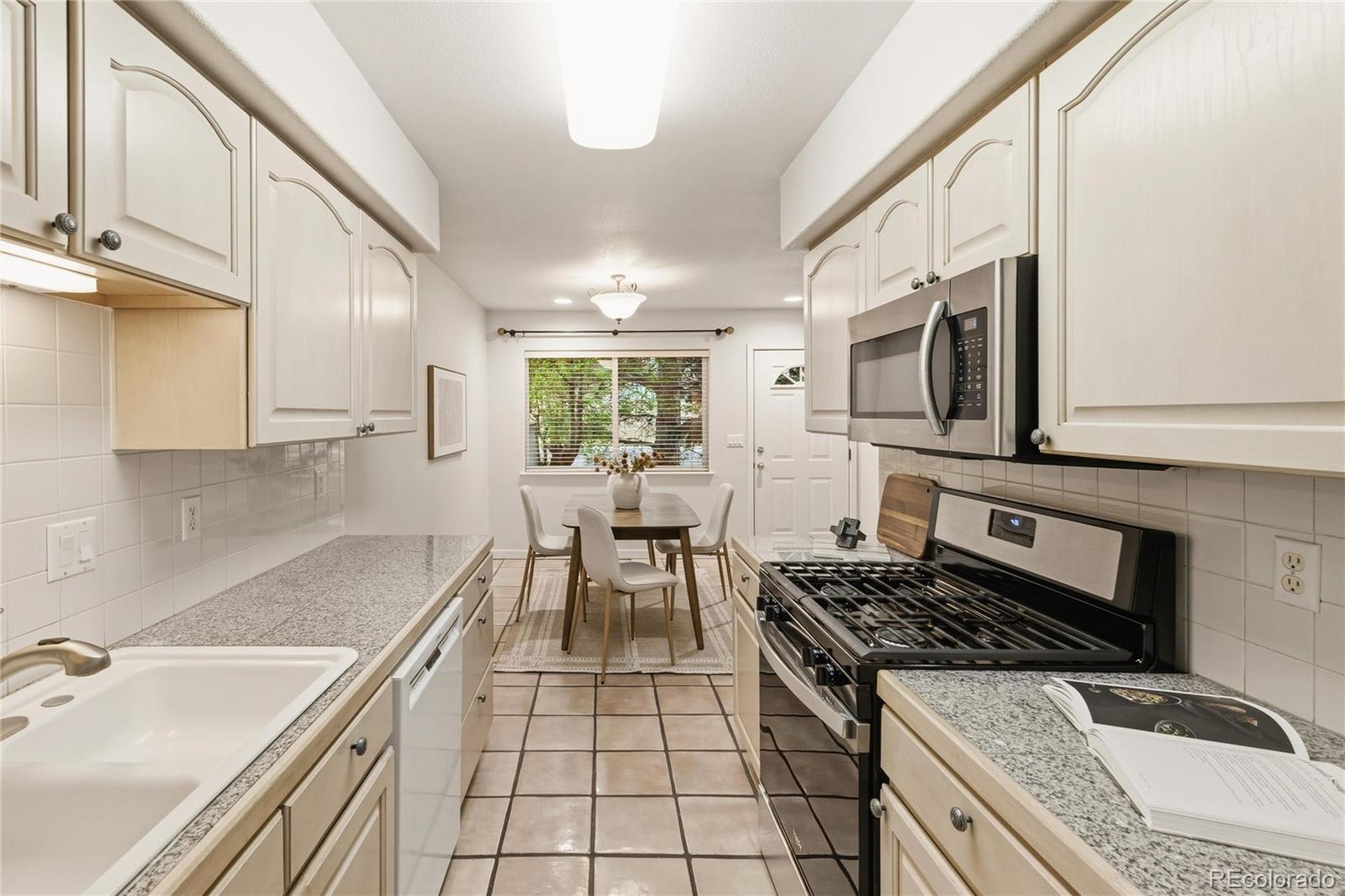 563 Ridgeview Drive Louisville, CO 80027 - Photo 17 of 33 a kitchen with a sink a stove and cabinets