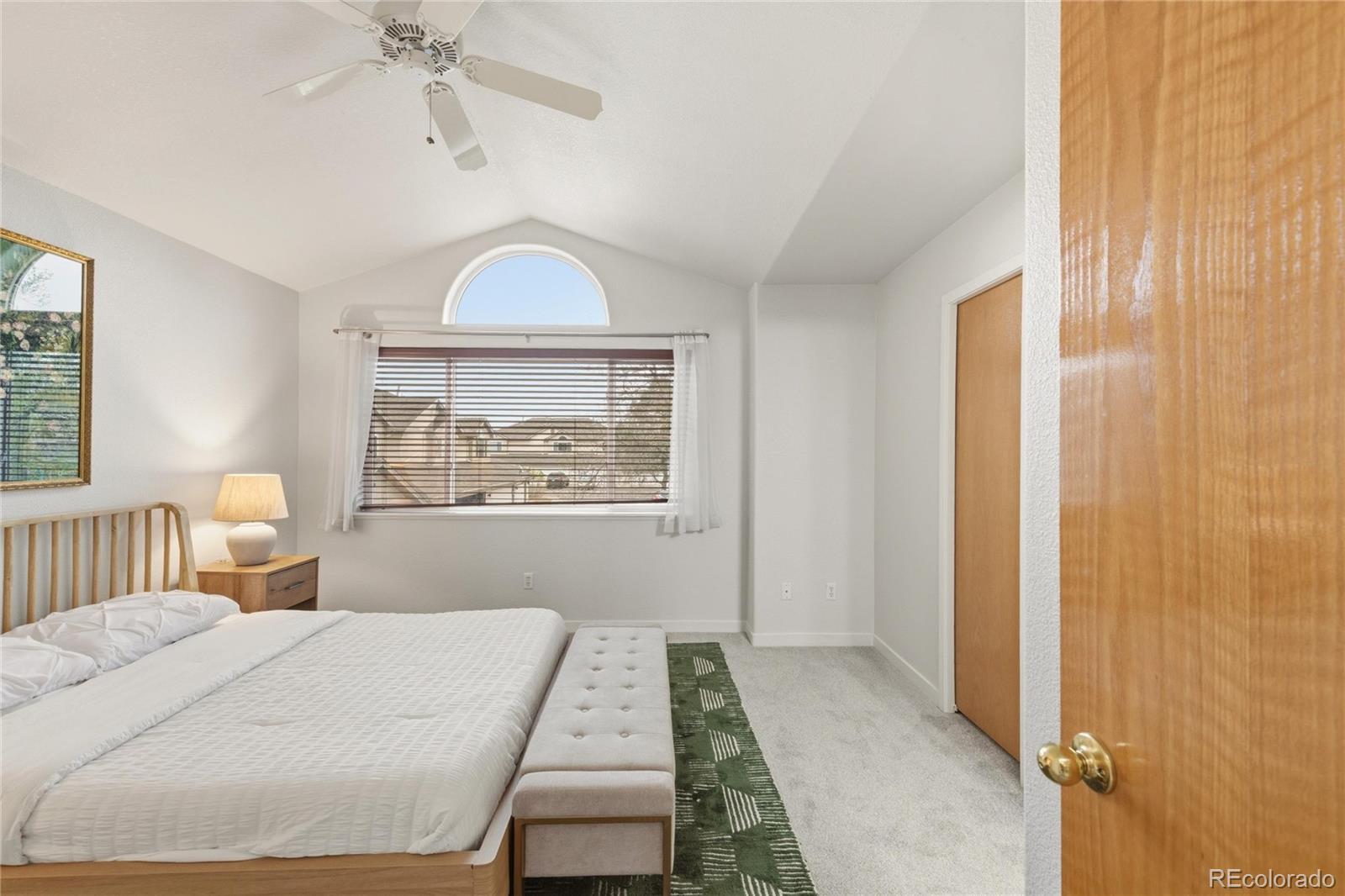 563 Ridgeview Drive Louisville, CO 80027 - Photo 19 of 33 a bedroom with a bed and a chandelier