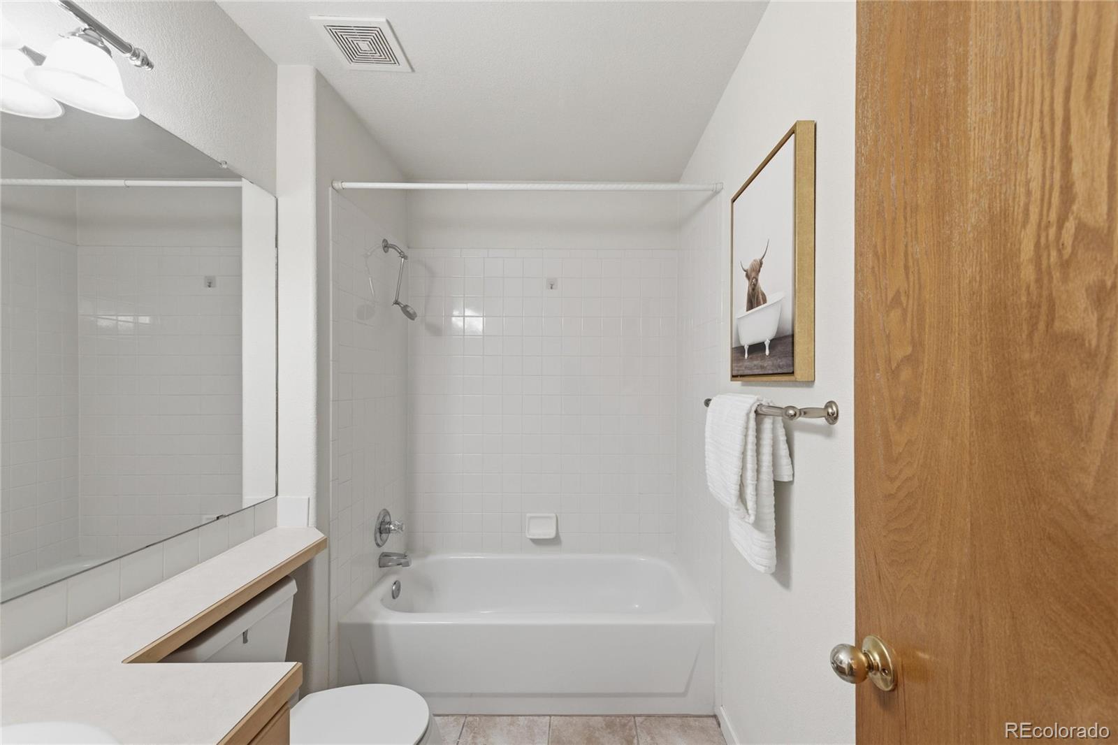 563 Ridgeview Drive Louisville, CO 80027 - Photo 26 of 33 a bathroom with a bathtub and a shower