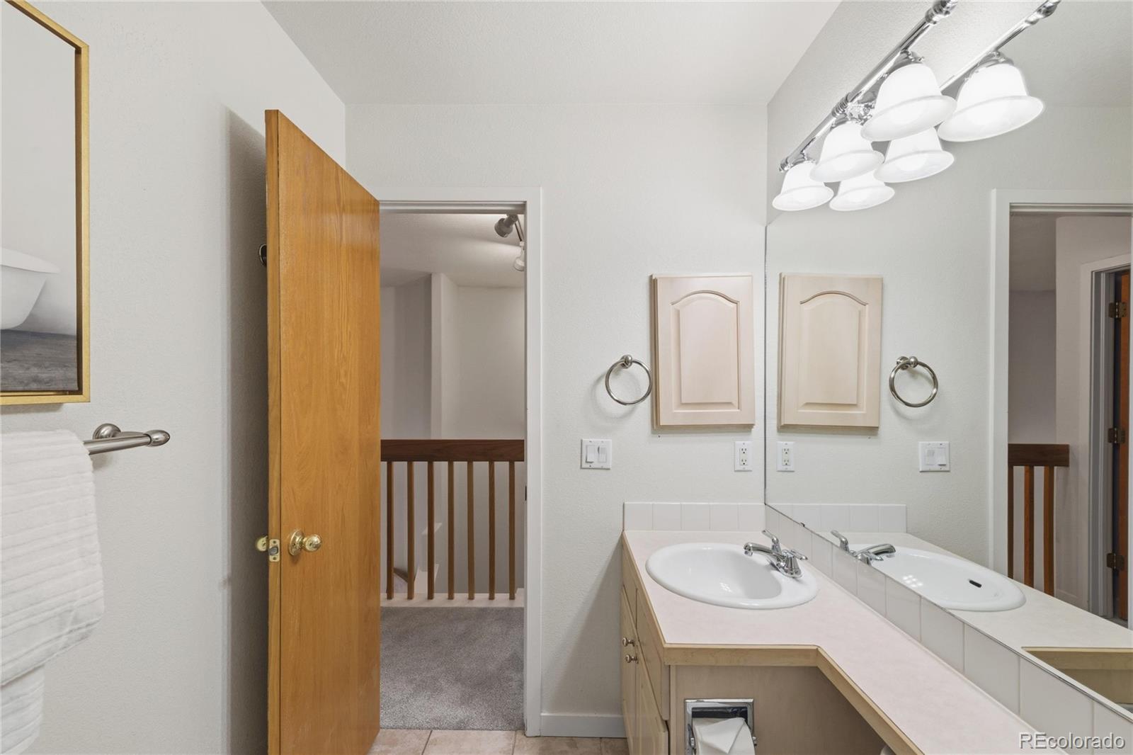 563 Ridgeview Drive Louisville, CO 80027 - Photo 27 of 33 a bathroom with a sink vanity granite and a mirror