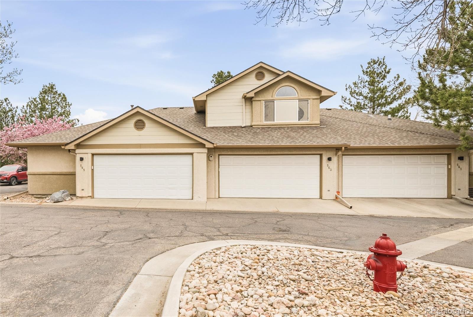 563 Ridgeview Drive Louisville, CO 80027 - Photo 30 of 33 a view of a house with a yard and garage