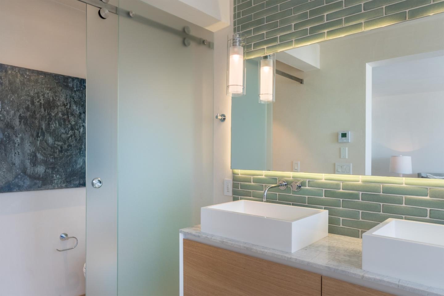 201 Cannery Row, Unit 3 Monterey, CA 93940 - Photo 16 of 19 a bathroom with a sink and a mirror