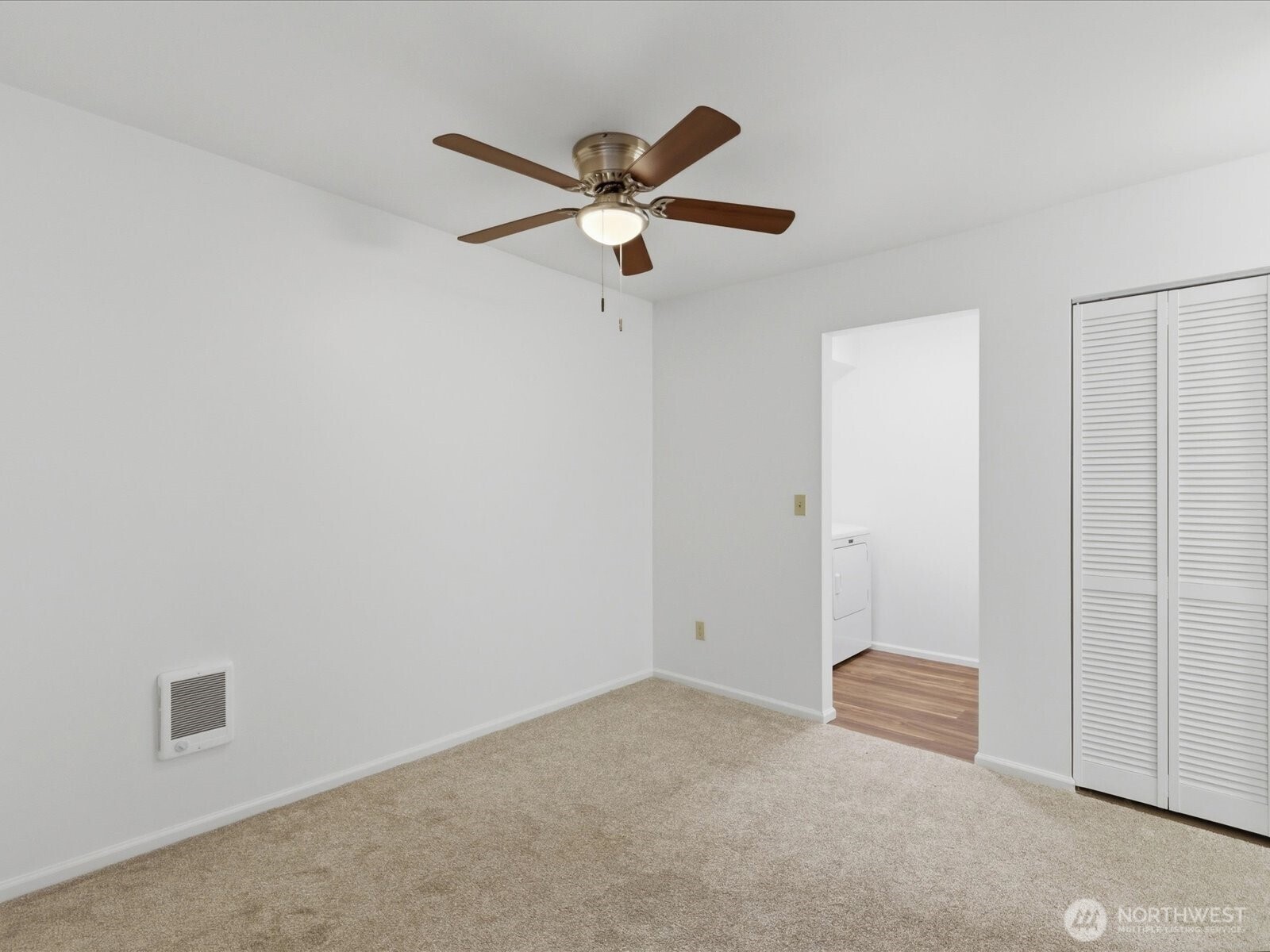 8835 166th Avenue Northeast, Unit D102 Redmond, WA 98052 - Photo 11 of 27 an empty room with closet and windows