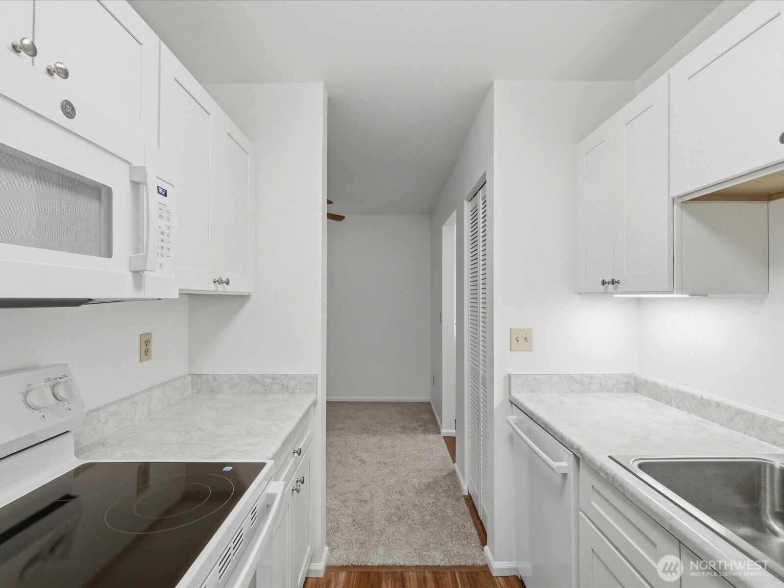 8835 166th Avenue Northeast, Unit D102 Redmond, WA 98052 - Photo 19 of 27 a kitchen with a sink stove and cabinets