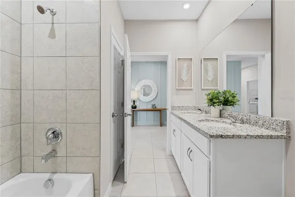 a bathroom with a granite countertop sink and mirror