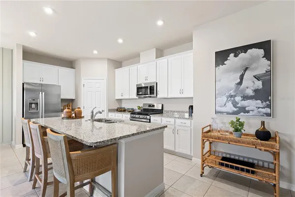 a kitchen with refrigerator and cabinets