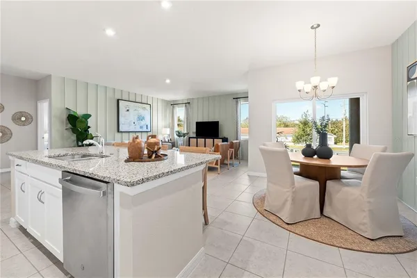 a kitchen with cabinets and chairs