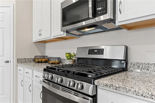 a stove top oven sitting inside of a kitchen