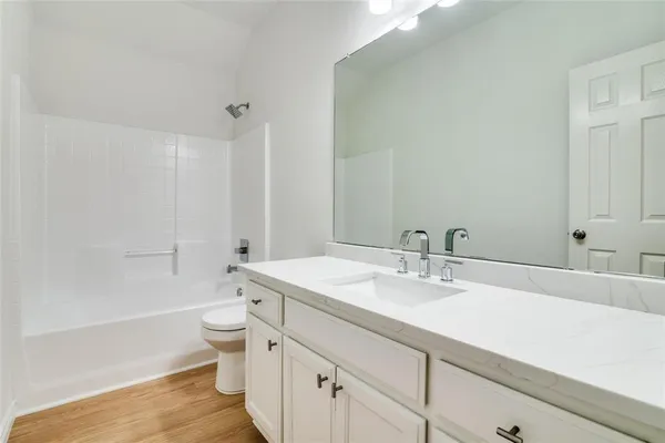 a bathroom with a sink a toilet and a bathtub