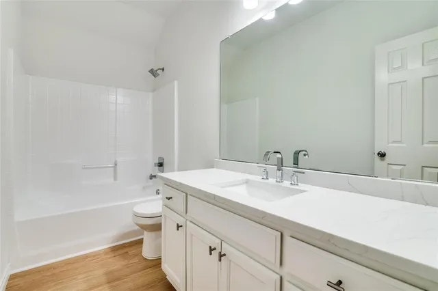 a bathroom with a sink a toilet and a bathtub