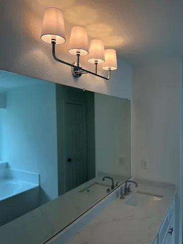 a bathroom with a sink and mirror