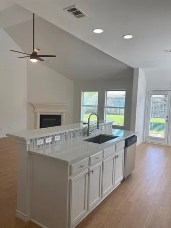 a kitchen with stainless steel appliances granite countertop a sink a stove and a refrigerator