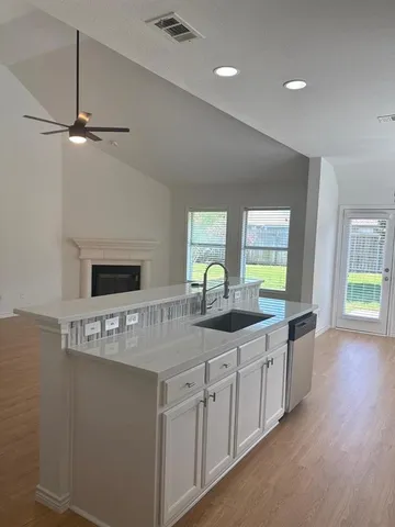 a kitchen with stainless steel appliances granite countertop a sink a stove and a refrigerator