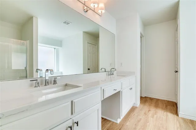 a bathroom with a double vanity sink mirror and