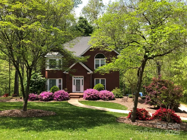 a front view of a house with a yard and fountain
