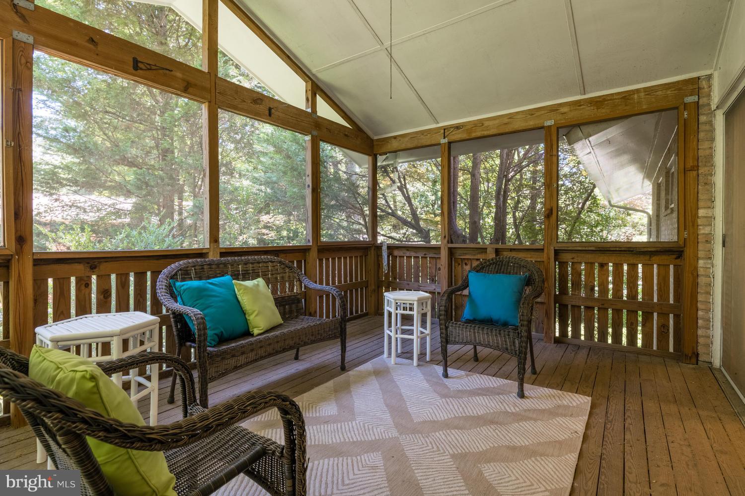 6805 Persimmon Tree Road Bethesda, MD 20817 - Photo 12 of 30 a balcony with wooden floor and outdoor seating