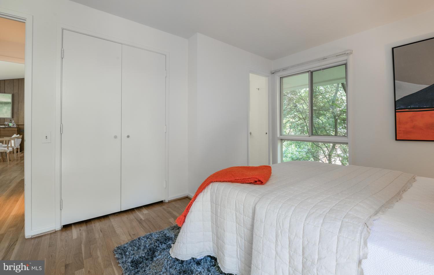 6805 Persimmon Tree Road Bethesda, MD 20817 - Photo 16 of 30 a bedroom with a bed and a window