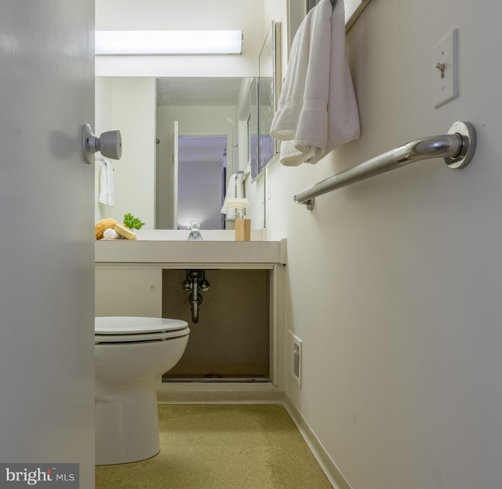 6805 Persimmon Tree Road Bethesda, MD 20817 - Photo 17 of 30 a bathroom with a sink and mirror