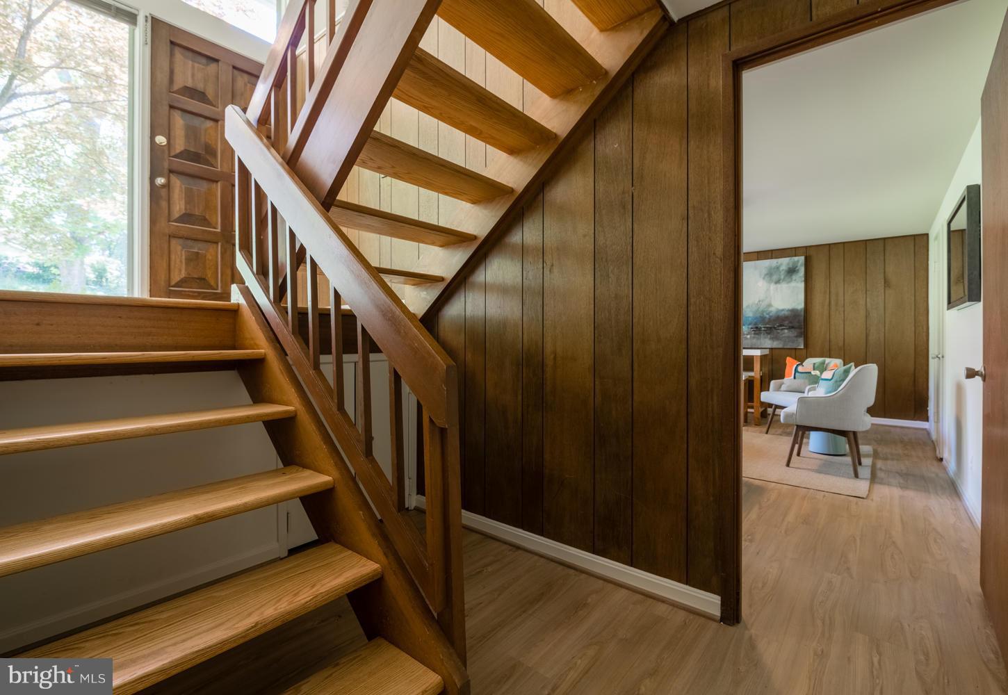 6805 Persimmon Tree Road Bethesda, MD 20817 - Photo 20 of 30 a view of staircase with wooden floor and furniture