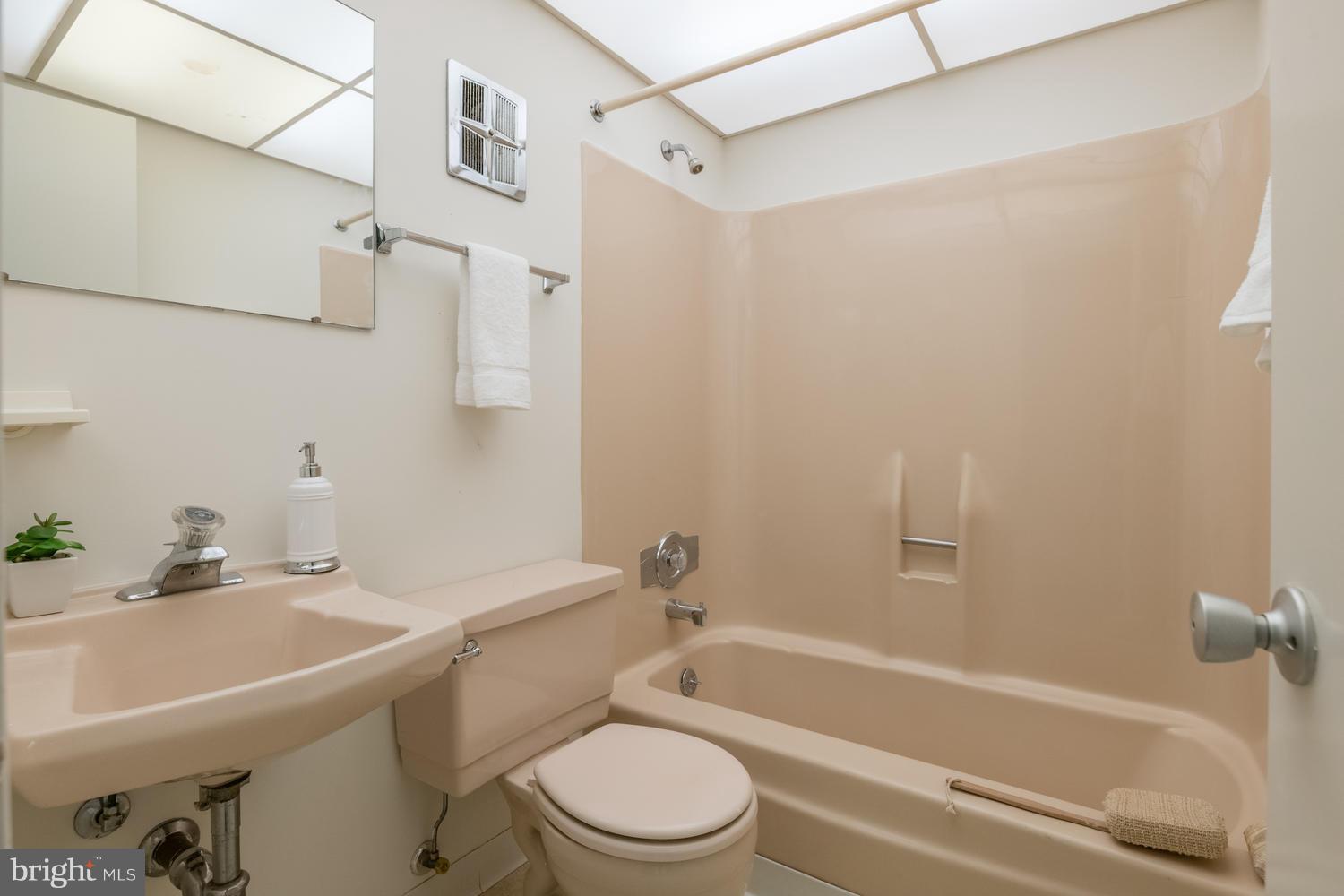 6805 Persimmon Tree Road Bethesda, MD 20817 - Photo 23 of 30 a bathroom with a sink a toilet and a bathtub