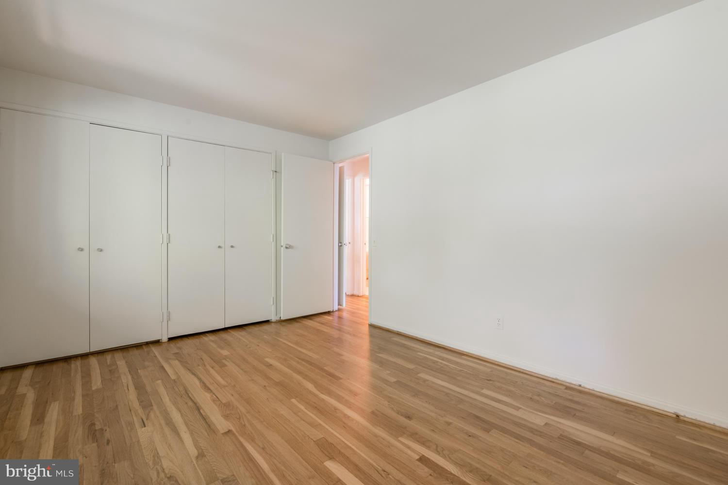 6805 Persimmon Tree Road Bethesda, MD 20817 - Photo 24 of 30 a view of an empty room with wooden floor