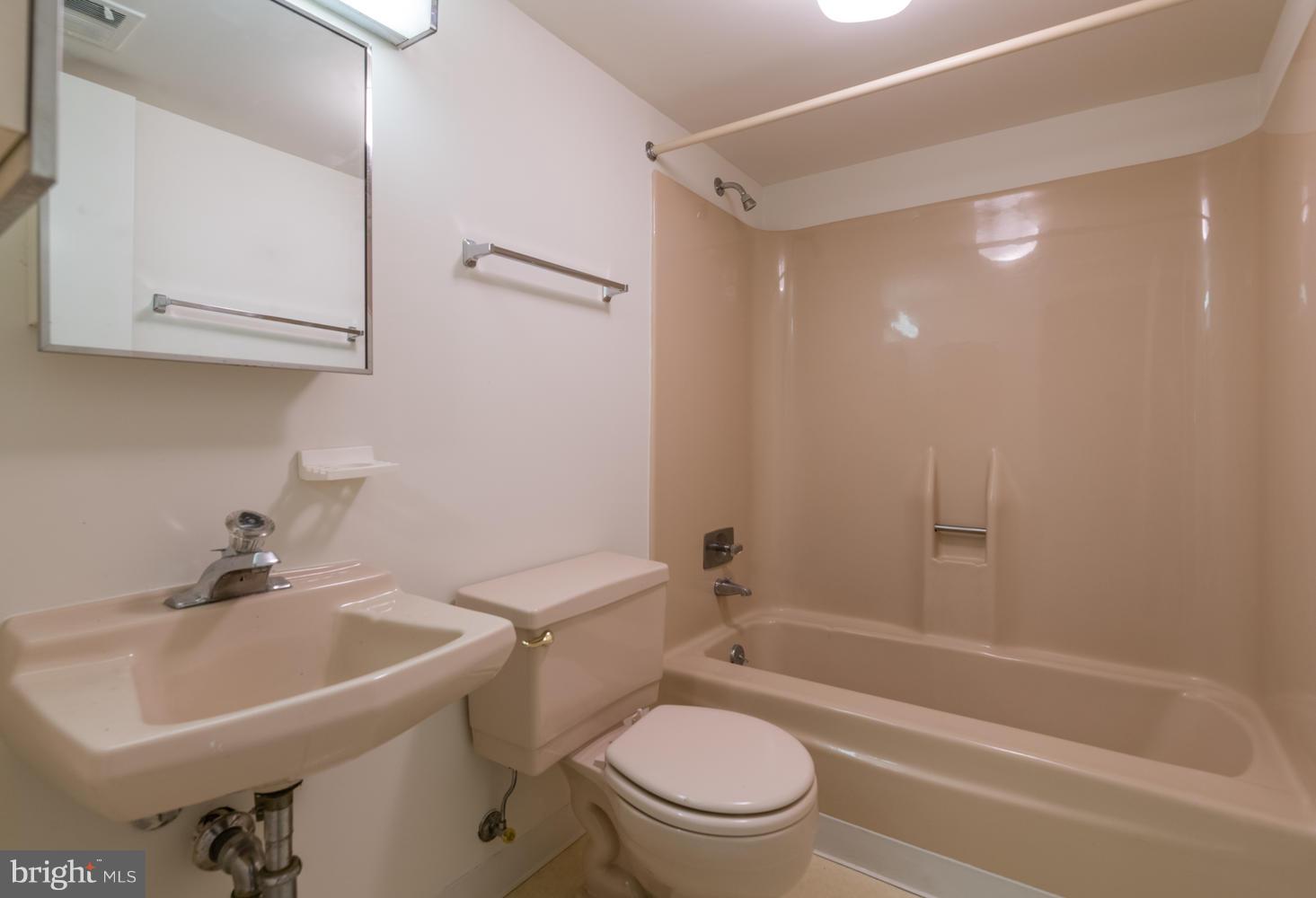 6805 Persimmon Tree Road Bethesda, MD 20817 - Photo 26 of 30 a bathroom with a sink toilet and shower