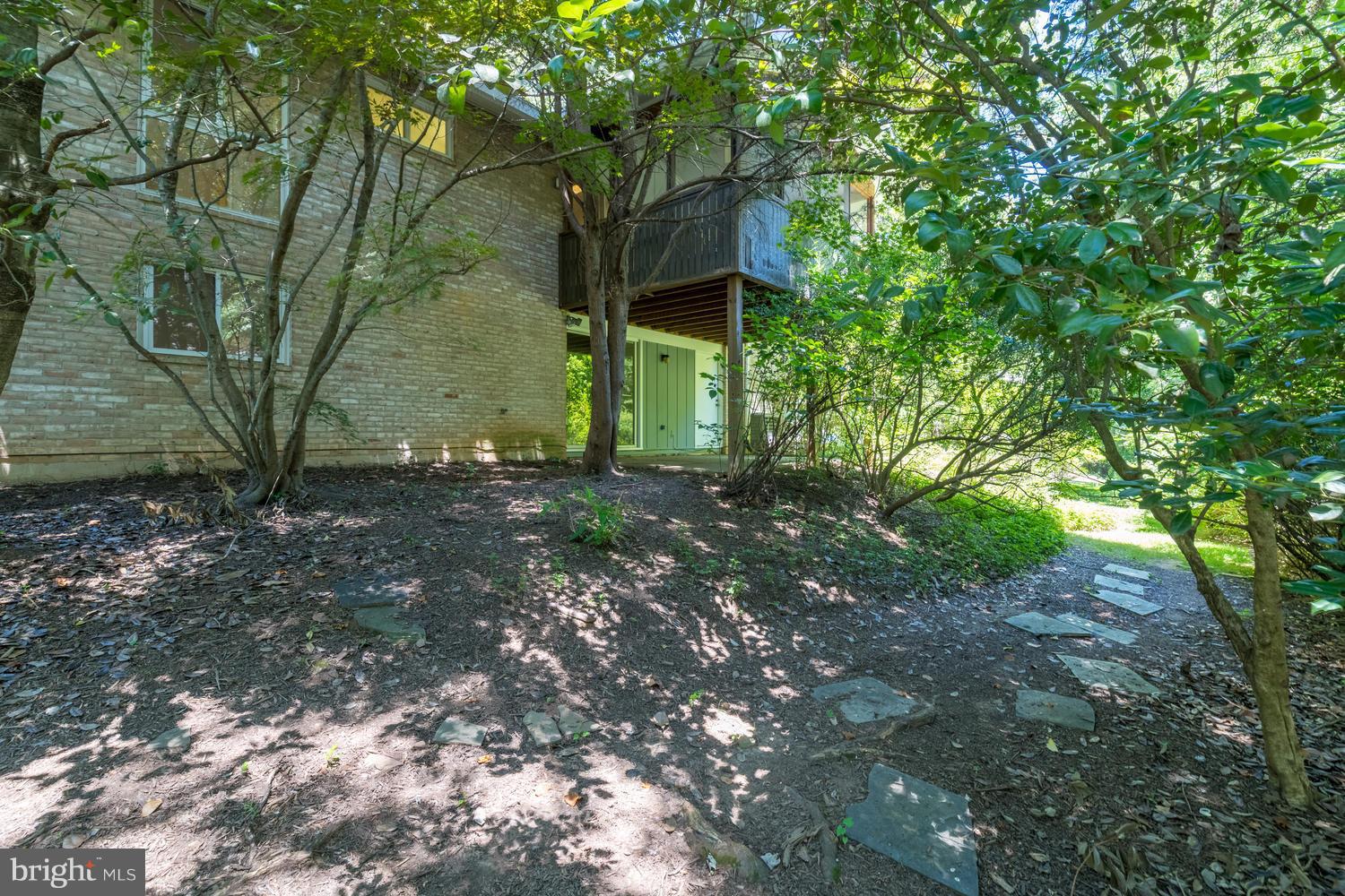 6805 Persimmon Tree Road Bethesda, MD 20817 - Photo 29 of 30 a backyard of a house with lots of green space