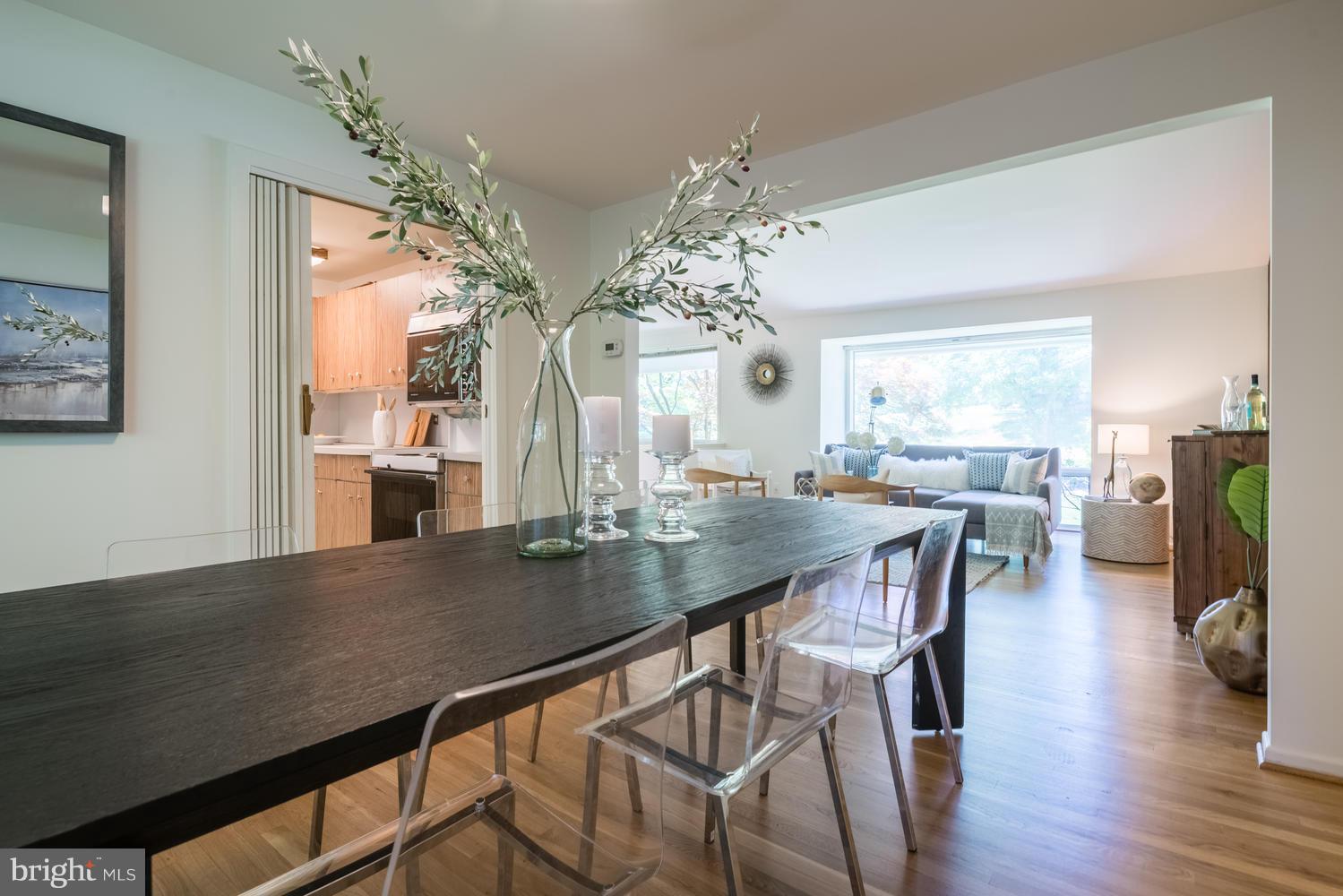 6805 Persimmon Tree Road Bethesda, MD 20817 - Photo 7 of 30 a view of a dining room with furniture window and wooden floor