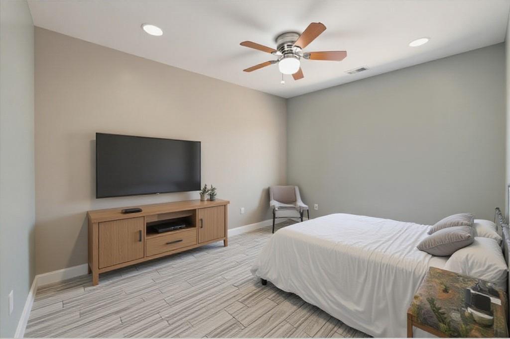 3087 Colonial Way, Unit J Atlanta, GA 30341 - Photo 11 of 21 a bedroom with a bed and a flat screen tv