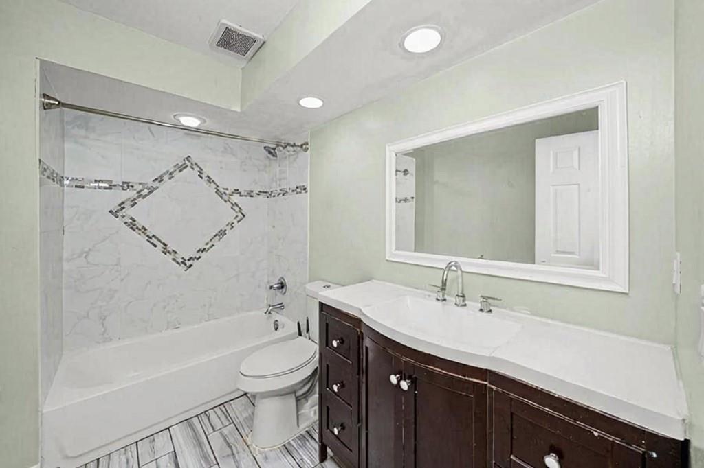 3087 Colonial Way, Unit J Atlanta, GA 30341 - Photo 12 of 21 a bathroom with a bathtub shower sink mirror and toilet