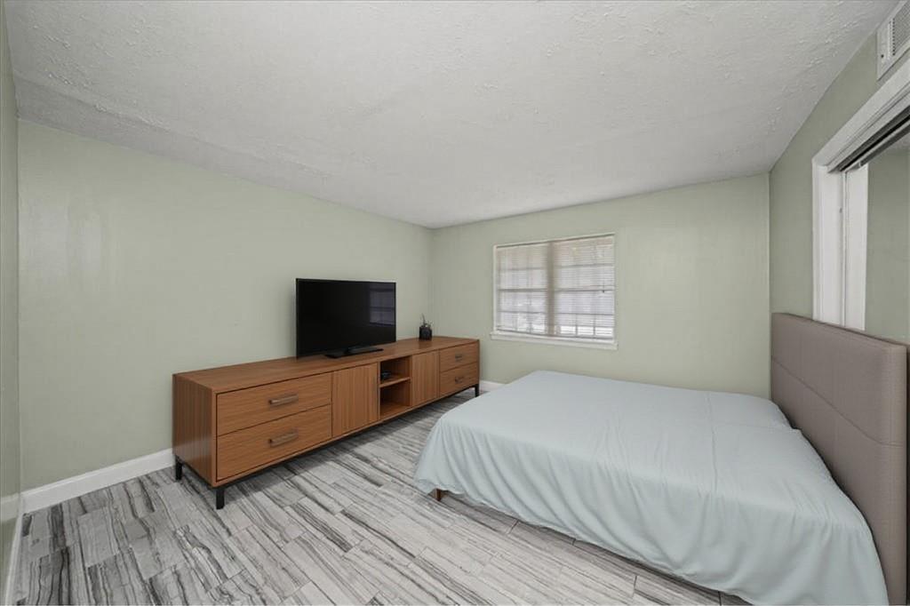 3087 Colonial Way, Unit J Atlanta, GA 30341 - Photo 13 of 21 a room with two bed and a flat screen tv
