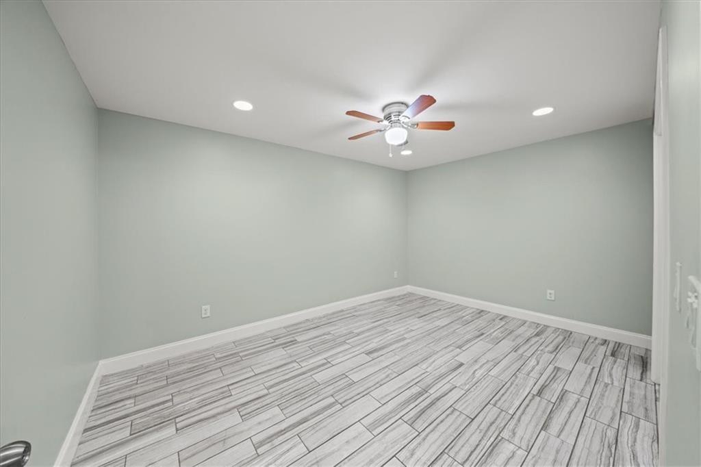 3087 Colonial Way, Unit J Atlanta, GA 30341 - Photo 17 of 21 a view of an empty room with a window and wooden floor