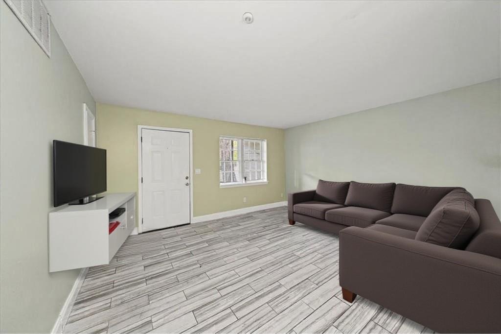 3087 Colonial Way, Unit J Atlanta, GA 30341 - Photo 4 of 21 a living room with furniture and a flat screen tv