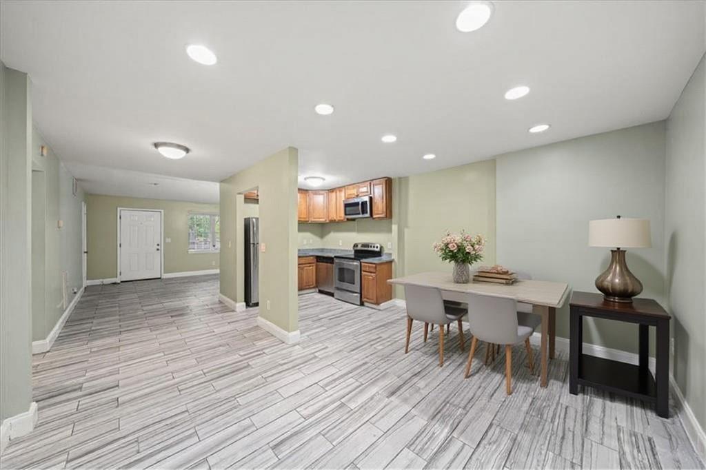 3087 Colonial Way, Unit J Atlanta, GA 30341 - Photo 5 of 21 a view of a kitchen with dining room and wooden floor