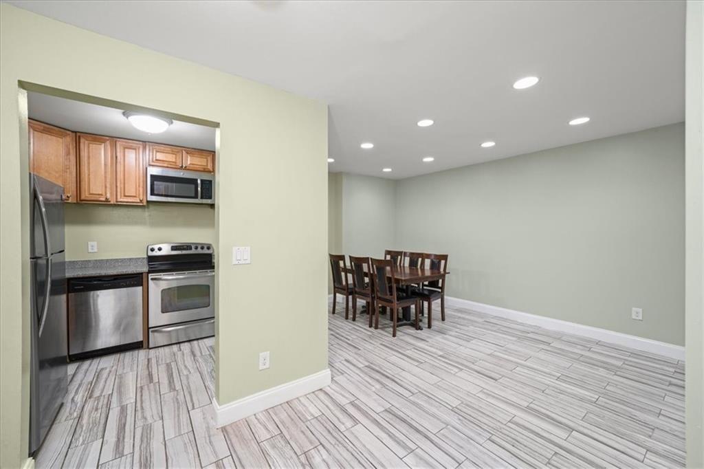 3087 Colonial Way, Unit J Atlanta, GA 30341 - Photo 8 of 21 a kitchen with stainless steel appliances granite countertop a stove and a wooden floors