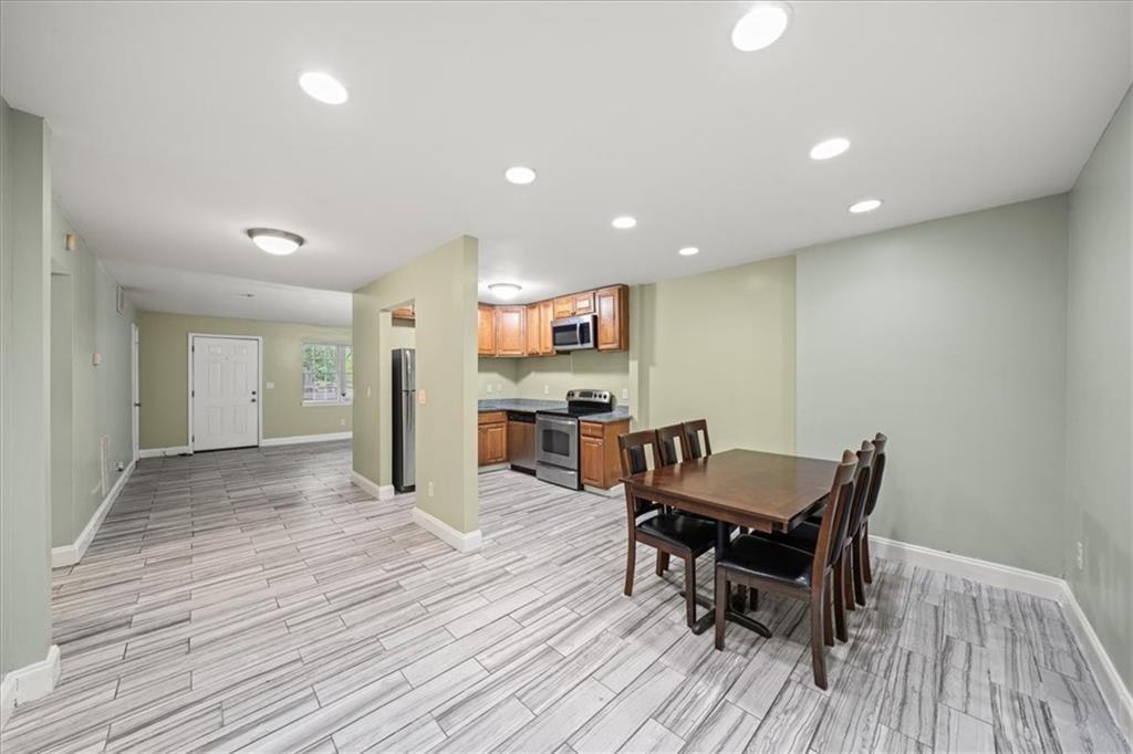 3087 Colonial Way, Unit J Atlanta, GA 30341 - Photo 9 of 21 a view of a dining room with furniture and wooden floor