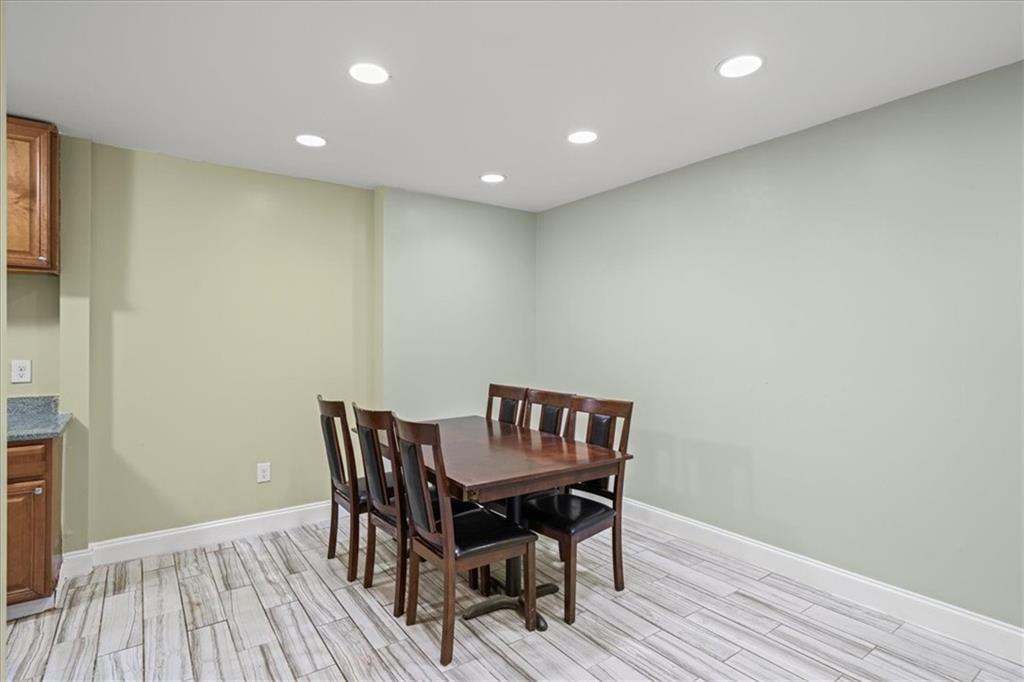 3087 Colonial Way, Unit J Atlanta, GA 30341 - Photo 10 of 21 a view of a dining room with wooden floor and a potted plant