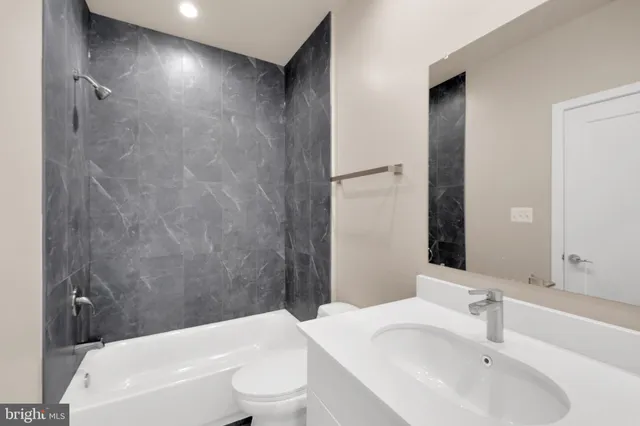 a bathroom with a toilet a sink and a bathtub