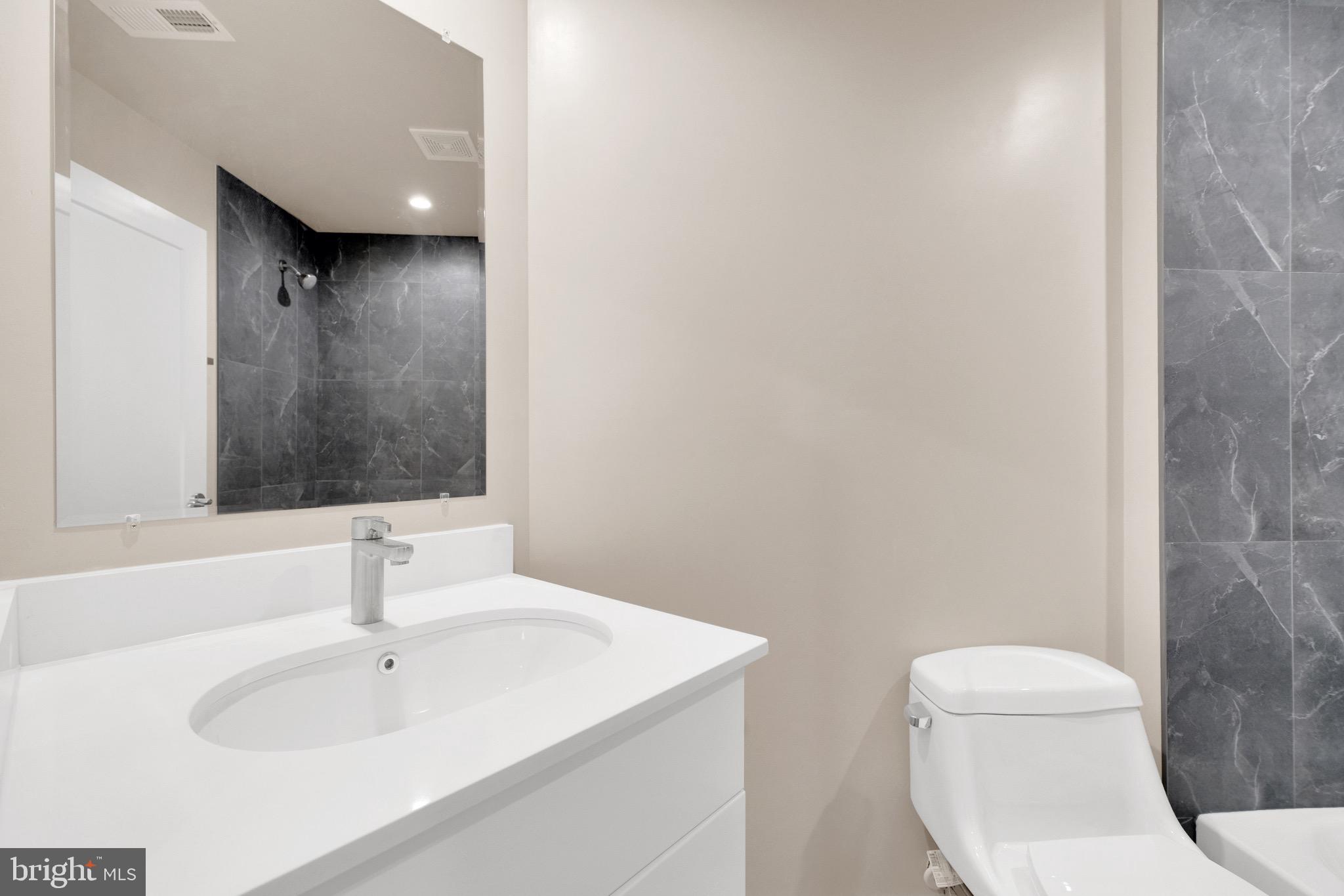 854 Xenia Street Southeast, Unit 102 Washington, DC 20032 - Photo 20 of 28 a bathroom with a sink and a mirror