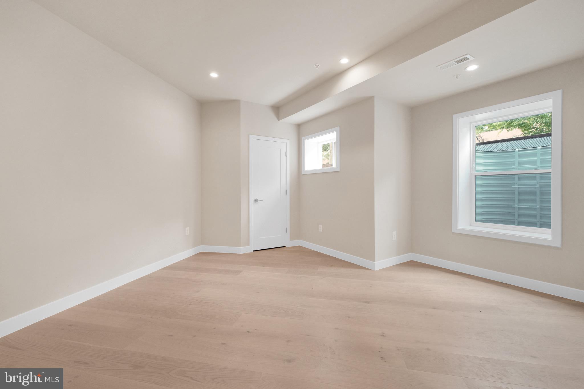 854 Xenia Street Southeast, Unit 102 Washington, DC 20032 - Photo 22 of 28 an empty room with windows