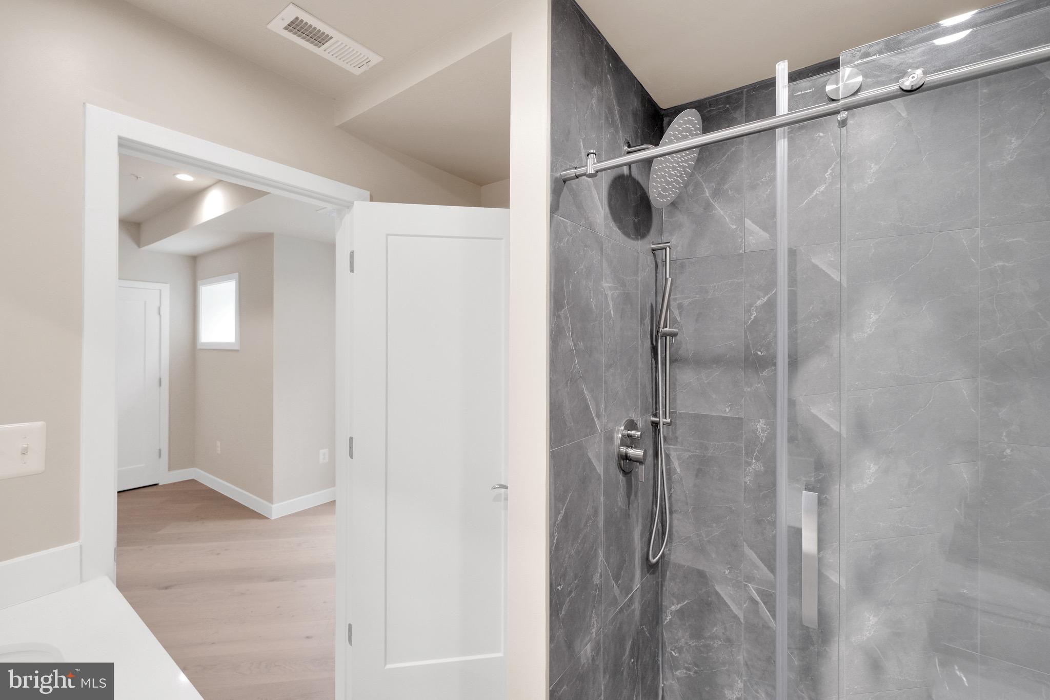 854 Xenia Street Southeast, Unit 102 Washington, DC 20032 - Photo 26 of 28 a bathroom with a shower