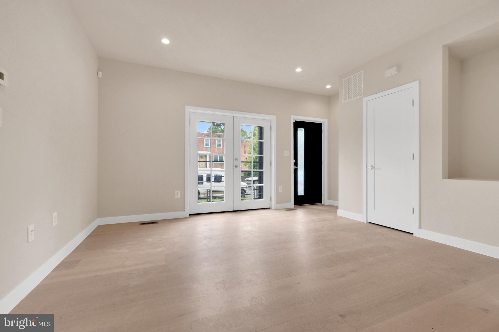 854 Xenia Street Southeast, Unit 102 Washington, DC 20032 - Photo 3 of 28 an empty room with an empty space and a window